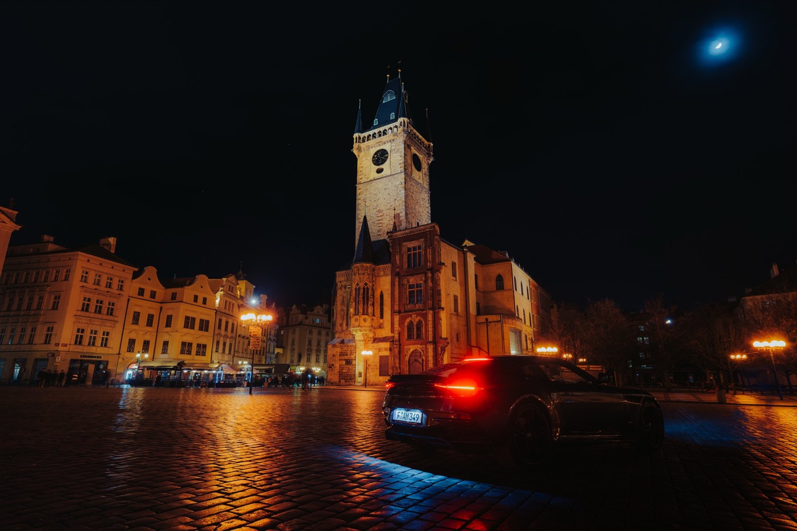 Aston Martin in Prague at night, architectural framing