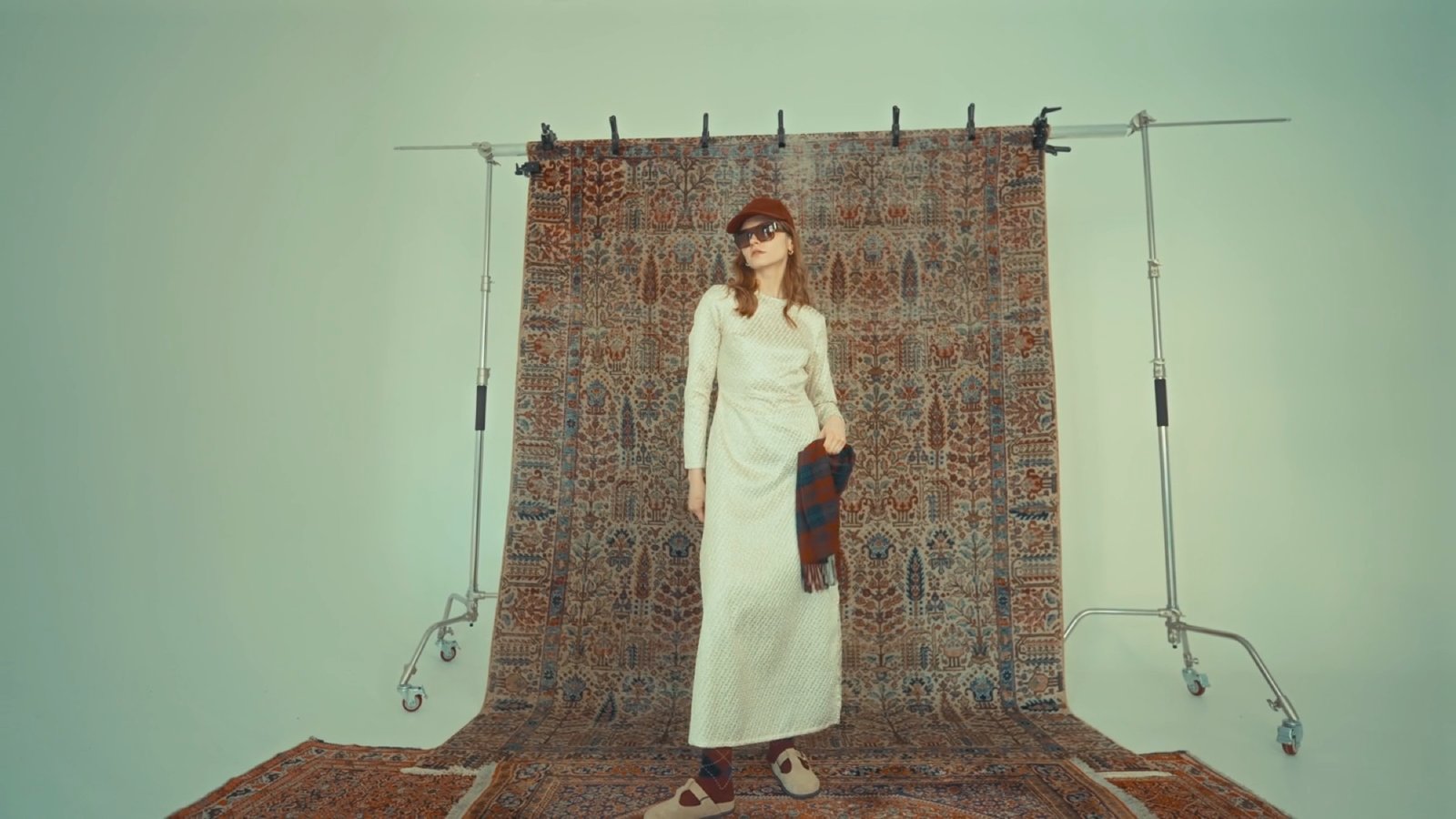 A Cettina Bucca FW25 look photographed against a hanging textile backdrop in the studio
