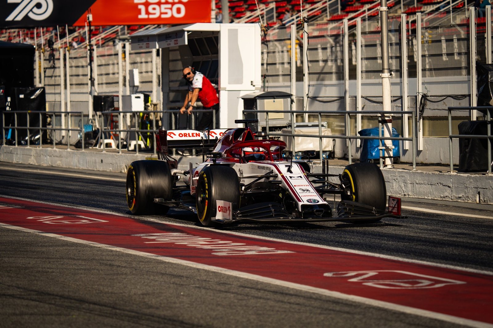 Alfa Romeo Racing C39 number 7 in the pit lane beneath the grandstand, Formula 1 pre-season testing, Barcelona 2020