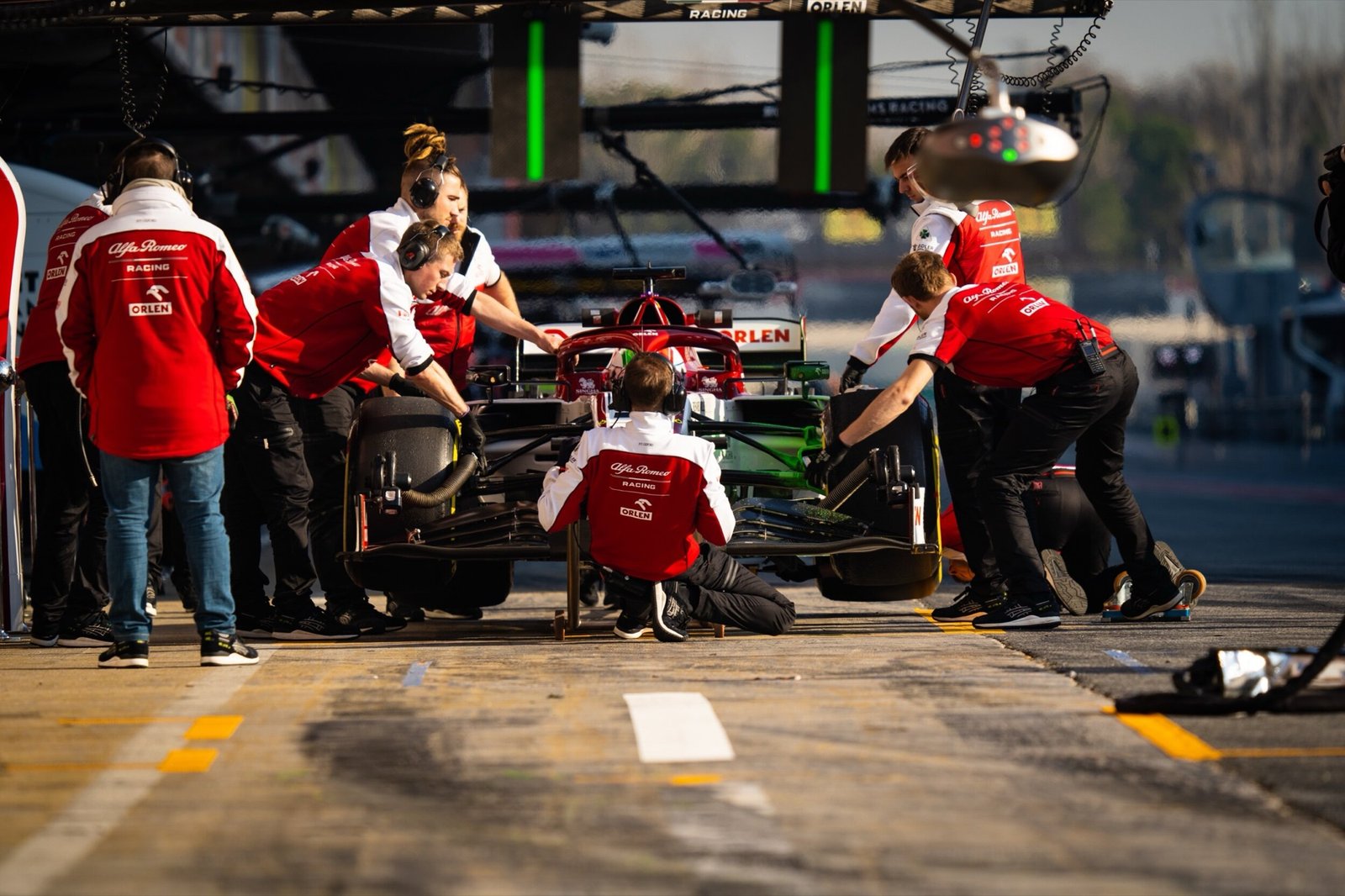 Alfa Romeo Racing mechanics working on the C39 in the pit box at Formula 1 pre-season testing, Barcelona 2020