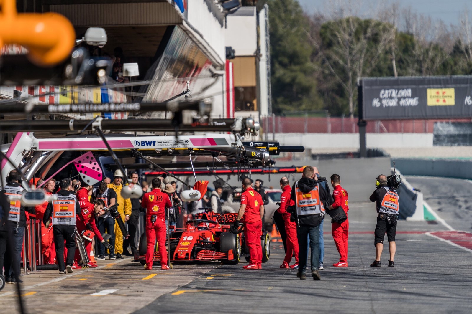 Ferrari SF1000 number 16 in the pit lane surrounded by team members and accredited media, Formula 1 pre-season testing, Barcelona 2020