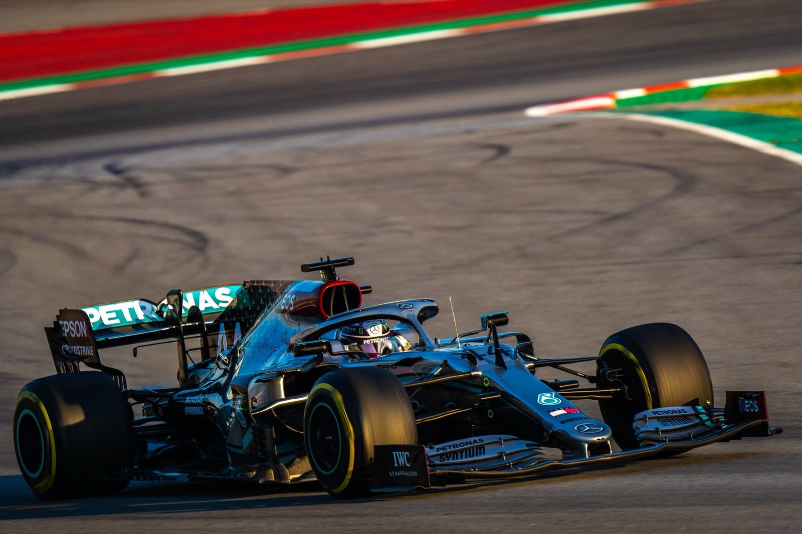 The Mercedes W11 in Petronas livery riding the kerb at Formula 1 pre-season testing, Barcelona 2020