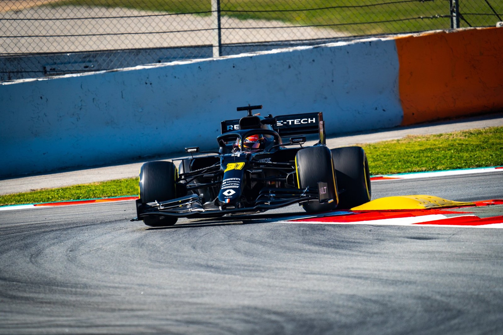 Renault R.S.20 number 31 clipping the yellow kerb at the track edge, Formula 1 pre-season testing, Barcelona 2020